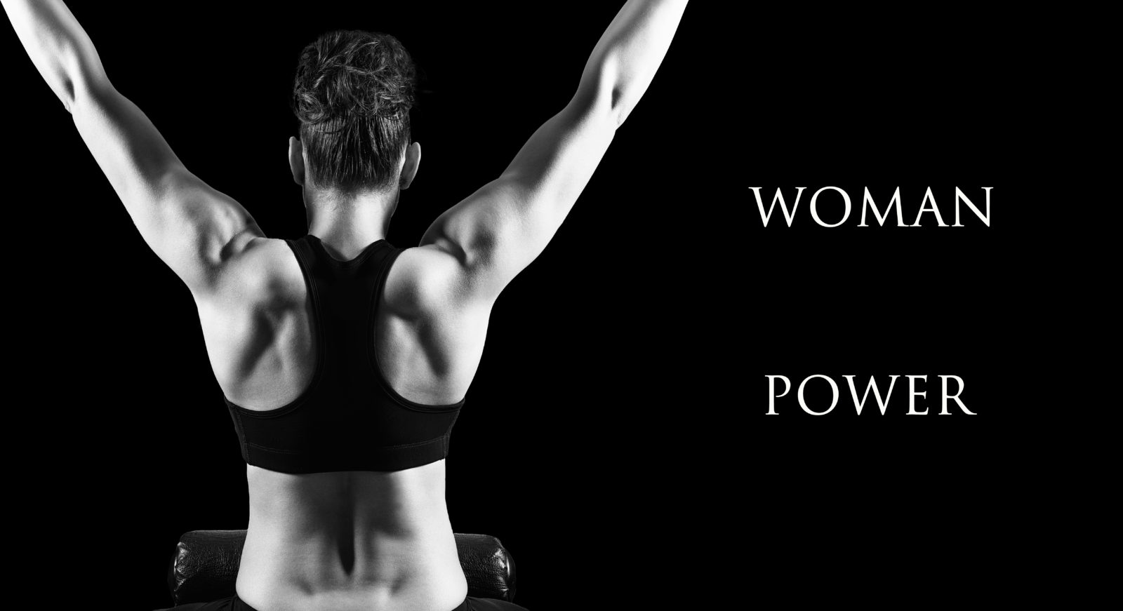 Muscular woman bodybuilder posing back over dark background.