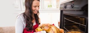 Woman smiling cooking turkey